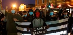 People hold up their fists after protesting near the spot where George Floyd died while in custody of the Minneapolis Police, on May 26, 2020 in Minneapolis, Minnesota. - A video of a handcuffed black man dying while a Minneapolis officer knelt on his neck for more than five minutes sparked a fresh furor in the US over police treatment of African Americans Tuesday. Minneapolis Mayor Jacob Frey fired four police officers following the death in custody of George Floyd on Monday as the suspect was pressed shirtless onto a Minneapolis street, one officer's knee on his neck. (Photo by Kerem Yucel / AFP)