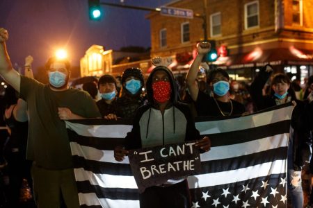 People hold up their fists after protesting near the spot where George Floyd died while in custody of the Minneapolis Police, on May 26, 2020 in Minneapolis, Minnesota. - A video of a handcuffed black man dying while a Minneapolis officer knelt on his neck for more than five minutes sparked a fresh furor in the US over police treatment of African Americans Tuesday. Minneapolis Mayor Jacob Frey fired four police officers following the death in custody of George Floyd on Monday as the suspect was pressed shirtless onto a Minneapolis street, one officer's knee on his neck. (Photo by Kerem Yucel / AFP)
