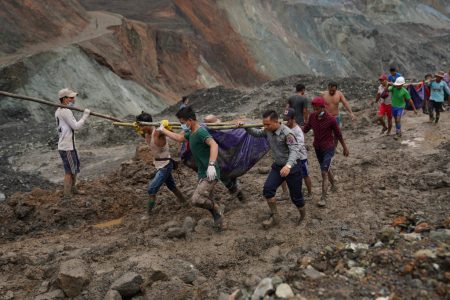 Rescuers recover bodies near the landslide area in the jade mining site in Hpakhant in Kachin state on July 2, 2020. - The battered bodies of more than 120 jade miners were pulled from a sea of mud after a landslide in northern Myanmar on July 2 after one of the worst-ever accidents to hit the treacherous industry. (Photo by Zaw Moe Htet / AFP)