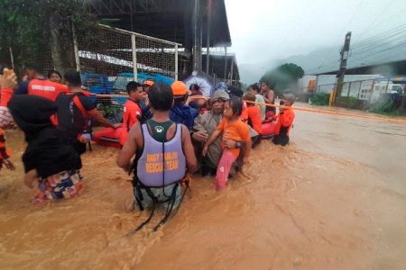 Philippine Coast Guard personnel assist in the evacuation of residents due to flooding caused by Typhoon Rai in Cagayan De Oro City, Philippines, December 16, 2021. Philippine Coast Guard/ Handout via REUTERS. THIS IMAGE HAS BEEN SUPPLIED BY A THIRD PARTY. NO RESALES. NO ARCHIVES. MANDATORY CREDIT