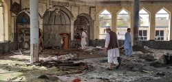 People inspect the inside of a mosque following a bombing in Kunduz province northern Afghanistan, Friday, Oct. 8, 2021. A powerful explosion in the mosque frequented by a Muslim religious minority in northern Afghanistan on Friday has left several casualties, witnesses and the Taliban's spokesman said. (AP Photo/Abdullah Sahil)
