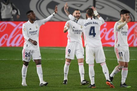 Real Madrid's French forward Karim Benzema (C) celebrates his goal during the Spanish league football match between Real Madrid CF and Granada FC at the Alfredo di Stefano stadium in Valdebebas, on the outskirts of Madrid on December 23, 2020. (Photo by OSCAR DEL POZO / AFP) (Photo by OSCAR DEL POZO/AFP via Getty Images)