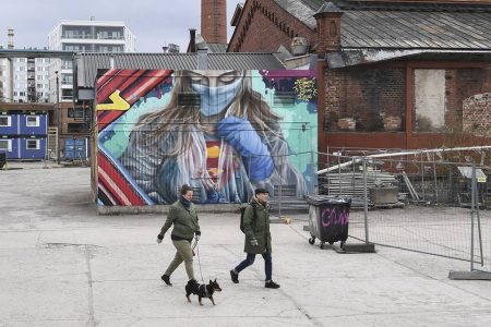 epa08385467 A view of a mural depicting a superhero character in protective gear, painted by a group of street artists in Helsinki, Finland, 26 April 2020, to pay tribute with to people working on the frontline of the coronavirus crisis.  EPA-EFE/KIMMO BRANDT