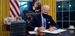 President Joe Biden signs his first executive order in the Oval Office of the White House on Wednesday, Jan. 20, 2021, in Washington. (AP Photo/Evan Vucci)