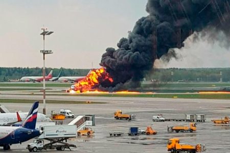 In this image provided by Riccardo Dalla Francesca shows smoke rises from a fire on a plane at Moscow's Sheremetyevo airport on Sunday, May 5, 2019. (Riccardo Dalla Francesca via AP)