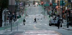 A man crosses a nearly empty street in San Francisco, Tuesday, March 17, 2020. Officials in seven San Francisco Bay Area counties have issued a shelter-in-place mandate affecting about 7 million people, including the city of San Francisco itself. The order says residents must stay inside and venture out only for necessities for three weeks starting Tuesday. (AP Photo/Jeff Chiu)