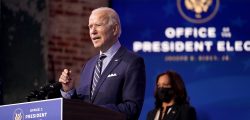 President-elect Joe Biden speaks at The Queen theater, Monday, Dec. 28, 2020, in Wilmington, Del. Vice President-elect Kamala Harris listens at right. (AP Photo/Andrew Harnik)