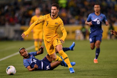 Australia's Mathew Leckie (C) tackles Nepal's Anjan Bista (bottom L) in the World Cup Qatar 2022 qualification round 2 football match between Australia and Nepal at the GIO Stadium in Canberra on October 10, 2019. (Photo by SAEED KHAN / AFP) / --IMAGE RESTRICTED TO EDITORIAL USE - STRICTLY NO COMMERCIAL USE-- (Photo by SAEED KHAN/AFP via Getty Images)