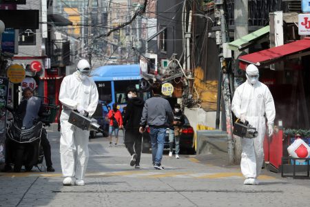 Quarantine workers spray disinfectants at night spots of Itaewon neighborhood, following the coronavirus disease (COVID-19) outbreak, in Seoul, South Korea, May 11, 2020. Yonhap/via REUTERS ATTENTION EDITORS - THIS IMAGE HAS BEEN SUPPLIED BY A THIRD PARTY. SOUTH KOREA OUT. NO RESALES. NO ARCHIVE.
