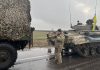 Ukrainian soldiers pose with captured military vehicles of Russian forces in the Nikolaev, a city near the Black Sea in southern Ukraine, on Wednesday March 2, 2022.
