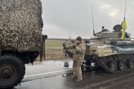 Ukrainian soldiers pose with captured military vehicles of Russian forces in the Nikolaev, a city near the Black Sea in southern Ukraine, on Wednesday March 2, 2022.