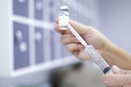 Female nurse filling syringe