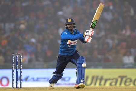 Sri Lanka batsman Asela Gunaratne plays a shot during the second One Day International (ODI) cricket match between India and Sri Lanka at The Punjab Cricket Association Stadium in Mohali on December 13, 2017. / AFP PHOTO / SAJJAD HUSSAIN / ----IMAGE RESTRICTED TO EDITORIAL USE - STRICTLY NO COMMERCIAL USE----- / GETTYOUT