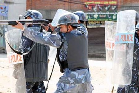 Police fire bullets back into the crowd of rock-throwers in Satdobado on Thursday.
April 20, 2006
         Post Photo/TODD KRAININ/KANTIPUR