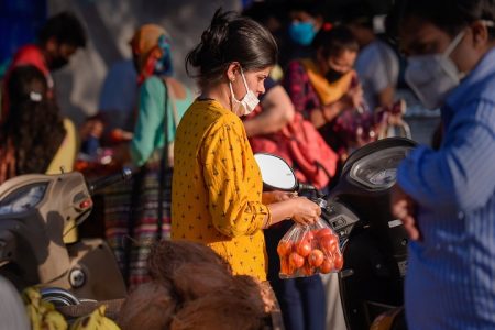 Ghaziabad: People wearing face masks buy essential items in a market during the nationwide lockdown imposed in the wake of coronavirus pandemic, in Ghaziabad, Wednesday, April 8, 2020. The Uttar Pradesh government on Wednesday decided to completely seal hotspots in 15 districts of the state till April 15 in an attempt to avoid community spread of the virus. (PTI Photo/Atul Yadav) (PTI08-04-2020_000220B)