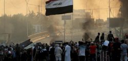 Anti-government protesters set fire and close streets during ongoing protests in Baghdad, Iraq on Saturday.