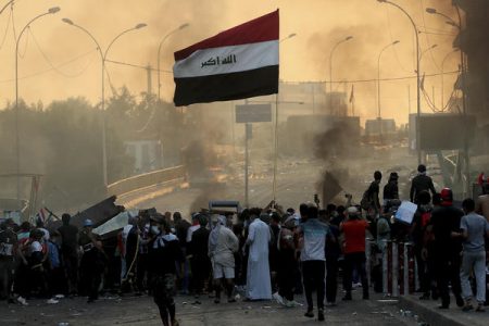 Anti-government protesters set fire and close streets during ongoing protests in Baghdad, Iraq on Saturday.