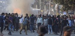 Protesters throw stones at security officers during a protest against the Citizenship Amendment Bill in Gauhati, India, on Wednesday.
