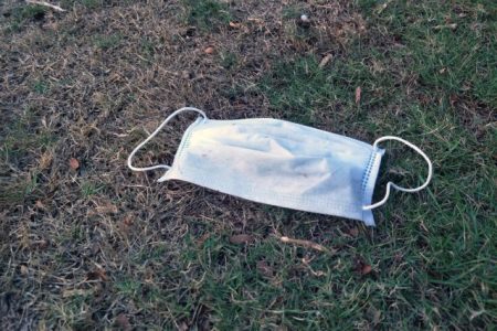 garbage flu mask drop on ground grass floor