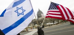 A pro-Israel demonstrators waves flags, toward the Capitol in Washington, Tuesday, March 3, 2015, as Israeli Prime Minister Benjamin Netanyahu addressed a joint meeting of Congress. In a speech that stirred political intrigue in two countries, Netanyahu told Congress that negotiations underway between Iran and the U.S. would "all but guarantee" that Tehran will get nuclear weapons, a step that the world must avoid at all costs. (AP Photo/Cliff Owen)