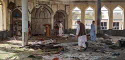 People inspect the inside of a mosque following a bombing in Kunduz province northern Afghanistan, Friday, Oct. 8, 2021. A powerful explosion in the mosque frequented by a Muslim religious minority in northern Afghanistan on Friday has left several casualties, witnesses and the Taliban's spokesman said. (AP Photo/Abdullah Sahil)
