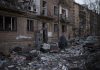 A resident carries a suitcase with his belongings after his building was heavily damaged by bombing in Kyiv, Ukraine, Friday, March 18, 2022. Russian forces pressed their assault on Ukrainian cities Friday, with new missile strikes and shelling on the edges of the capital Kyiv and the western city of Lviv, as world leaders pushed for an investigation of the Kremlin’s repeated attacks on civilian targets, including schools, hospitals and residential areas. (AP Photo/Felipe Dana)