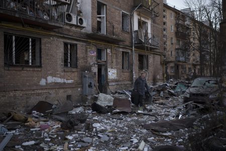 A resident carries a suitcase with his belongings after his building was heavily damaged by bombing in Kyiv, Ukraine, Friday, March 18, 2022. Russian forces pressed their assault on Ukrainian cities Friday, with new missile strikes and shelling on the edges of the capital Kyiv and the western city of Lviv, as world leaders pushed for an investigation of the Kremlin’s repeated attacks on civilian targets, including schools, hospitals and residential areas. (AP Photo/Felipe Dana)