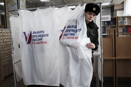 A student of the Maritime State University named after admiral Gennady Nevelskoy leaves a voting booth at a polling station during a presidential election in the Pacific port city of Vladivostok, 6418 kms. (3566 miles) east of Moscow, Russia, Friday, March 15, 2024. Voters in Russia are heading to the polls for a presidential election that is all but certain to extend President Vladimir Putin's rule after he clamped down on dissent. (AP Photo)