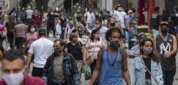 People walk through a downtown shopping district in Sao Paulo, Brazil, Wednesday, June 10, 2020. Retail shops reopened on Wednesday in Brazil's biggest city after a two-month coronavirus pandemic shutdown that aimed to contain the spread of the new coronavirus. (AP Photo/Andre Penner)