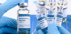 Coronavirus COVID-19 single dose small vials and multi dose in scientist hands concept. Research for new novel corona virus immunization drug.