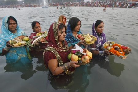 Hindu devotees offer prayers to the Sun god during the Hindu religious festival "Chhat Puja" in the northern Indian city of Chandigarh November 1, 2011. Hindu devotees worship the Sun god and fast all day for the betterment of their family and society during the festival. REUTERS/Ajay Verma (INDIA - Tags: RELIGION SOCIETY)