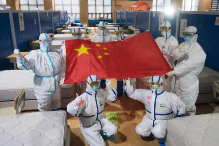 (200311) -- WUHAN, March 11, 2020 (Xinhua) -- Medical workers pose for photos after seeing cured patients off at the Wuchang temporary hospital in Wuhan, central China's Hubei Province, March 10, 2020.
  The last two temporary hospitals in Wuhan, the epicenter of the coronavirus outbreak in central China's Hubei Province, were shut down Tuesday, marking the closure of all 16 temporary hospitals in the city. (Xinhua/Xiao Yijiu)