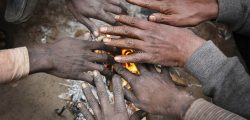 Indian men warm their hands near a bonfire on a cold and foggy morning in Allahabad, India, Sunday, Dec. 21, 2014. Intense cold wave continues unabated in north India with fog disrupting traffic movements at several places. (AP Photo/Rajesh Kumar Singh)