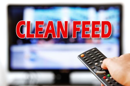 Out of focus TV LCD set and remote control in man's hand isolated over a white background.