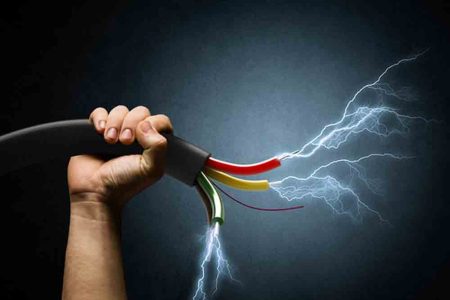 Close up image of human hand holding cable