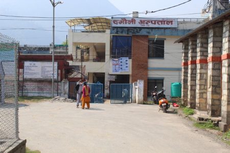 Two persons standing in front of Damauli Hospital in Tanahun district, on Tuesday, March 31, 2020. Photo: Madan Wagle/ THT