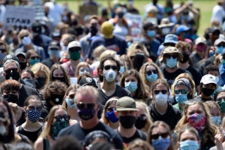 PLEASANTON, CA - JUNE 5: Protesters wear masks while attending a Black Lives Matter protest at Amador Valley Community Park in Pleasanton, Calif., on Friday, June 5, 2020. About 3,000 protesters gathered at Amador Valley Community Park and listened to speakers and then marched to the corner of Hopyard Road and Valley Ave. where they took a knee for 8 min and 46 seconds. (Jose Carlos Fajardo/Bay Area News Group)