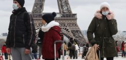 People wear a protective facemask as they walk in front the Eiffel tower, in Paris, on March 12, 2020 during a world COVID-19 outbreak. - The novel coronavirus "is a controllable pandemic" if countries step up measures to tackle it, the head of the World Health Organization (WHO) said March 12, 2020. More than 4,500 people have died, according to an AFP tally, while the WHO said some 125,000 cases had been reported from 118 countries and territories. The pandemic has disrupted cultural and sporting events around the world as authorities try to prevent large gatherings. (Photo by Ludovic Marin / AFP) (Photo by LUDOVIC MARIN/AFP via Getty Images)