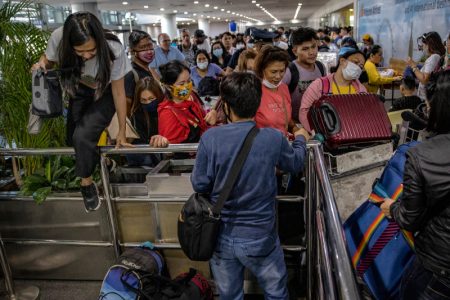 MANILA, PHILIPPINES - MARCH 14: Filipinos hoping to get on flights out of Manila hours before it is placed on lockdown queue at Ninoy Aquino International Airport on March 14, 2020 in Manila, Philippines. Philippine President Rodrigo Duterte announced on Thursday that he would place some 12 million people in the capital Manila on lockdown and suspend government work for a month to prevent the spread of COVID-19. The Philippines' Department of Health has so far confirmed 98 cases of the deadly coronavirus in the country, with at least 8 recorded fatalities. (Photo by Ezra Acayan/Getty Images)
