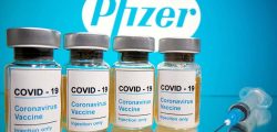 FILE - Vials with a sticker reading, "COVID-19 / Coronavirus vaccine / Injection only" and a medical syringe are seen in front of a displayed Pfizer logo in this illustration taken on October 31, 2020. Illustration: Reuters via Dado Ruvic