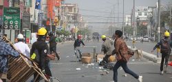 Protesters-rush-to-try-to-block-the-road-as-police-arrive-during-a-protest-against-the-military-coup-in-Mandalay--Myanmar--on-Sunday.-_177ebc8356a_large