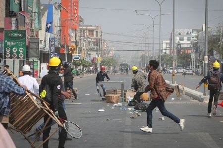 Protesters-rush-to-try-to-block-the-road-as-police-arrive-during-a-protest-against-the-military-coup-in-Mandalay--Myanmar--on-Sunday.-_177ebc8356a_large
