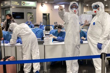 Russian medical experts prepare to check passengers arriving from Italy at Sheremetyevo airport outside Moscow, Russia, Sunday, March 8, 2020. The Russian authorities have ordered mandatory medical checks upon arrival for all those who arrive from countries with high a level of coronavirus cases and ordered them to stay home for two weeks. (AP Photo/Alexander Zemlianichenko)