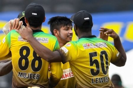 TAROUBA, TRINIDAD AND TOBAGO - AUGUST 22: Sandeep Lamichhane (2R) and Glenn Phillips (2L) of Jamaica Tallawahs celebrate the dismissal of Sherfane Rutherford (L) of Guyana Amazon Warriors during the Hero Caribbean Premier League match 8 between Guyana Amazon Warriors and Jamaica Tallawahs at Brian Lara Cricket Academy on August 22, 2020 in Tarouba, Trinidad And Tobago. (Photo by Randy Brooks - CPL T20/CPL T20 via Getty Images)