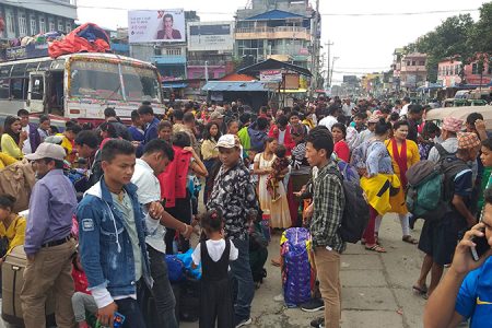 Travellers who have been stranded in lack of sufficient vehicles during Dashain festival, in Bhanuchok, Dharan, on Friday, October 4, 2019. Photo: Santosh Kafle/THT