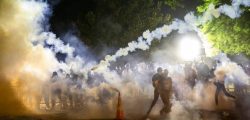 Tear gas rises above as protesters face off with police during a demonstration outside the White House over the death of George Floyd at the hands of Minneapolis Police in Washington, DC, on May 31, 2020. - Thousands of National Guard troops patrolled major US cities after five consecutive nights of protests over racism and police brutality that boiled over into arson and looting, sending shock waves through the country. The death Monday of an unarmed black man, George Floyd, at the hands of police in Minneapolis ignited this latest wave of outrage in the US over law enforcement's repeated use of lethal force against African Americans -- this one like others before captured on cellphone video. (Photo by Samuel Corum / AFP)