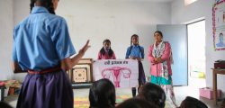 A teacher talks to a group of students about Menstrual Health Management (MHM) in a classroom in Phulwari Sharif, Patna, Bihar.