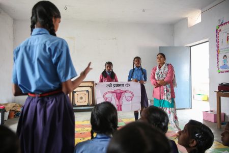 A teacher talks to a group of students about Menstrual Health Management (MHM) in a classroom in Phulwari Sharif, Patna, Bihar.
