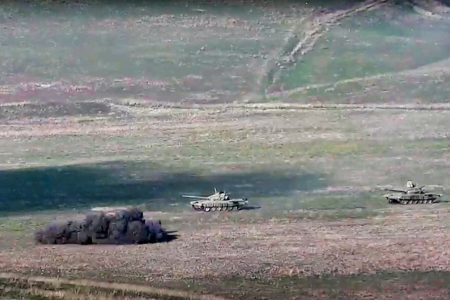 In this image taken from a footage released by Armenian Defense Ministry on Sunday, Sept. 27, 2020, Armenian army destroys Azerbaijani tanks at the contact line of the self-proclaimed Republic of Nagorno-Karabakh, Azerbaijan. Fighting between Armenia and Azerbaijan has broken out around the separatist region of Nagorno-Karabakh and the Armenian Defense Ministry says two Azerbaijani helicopters have been shot down. Ministry spokeswoman Shushan Stepanyan also said Armenian forces hit three Azerbaijani tanks. (Armenian Defense Ministry via AP)