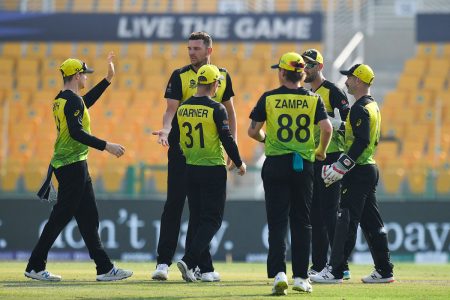 Australia's cricketers celebrate after the dismissal of West Indies' Shimron Hetmyer during the ICC men's Twenty20 World Cup cricket match between Australia and West Indies at the Sheikh Zayed Cricket Stadium in Abu Dhabi on November 6, 2021. (Photo by INDRANIL MUKHERJEE / AFP)